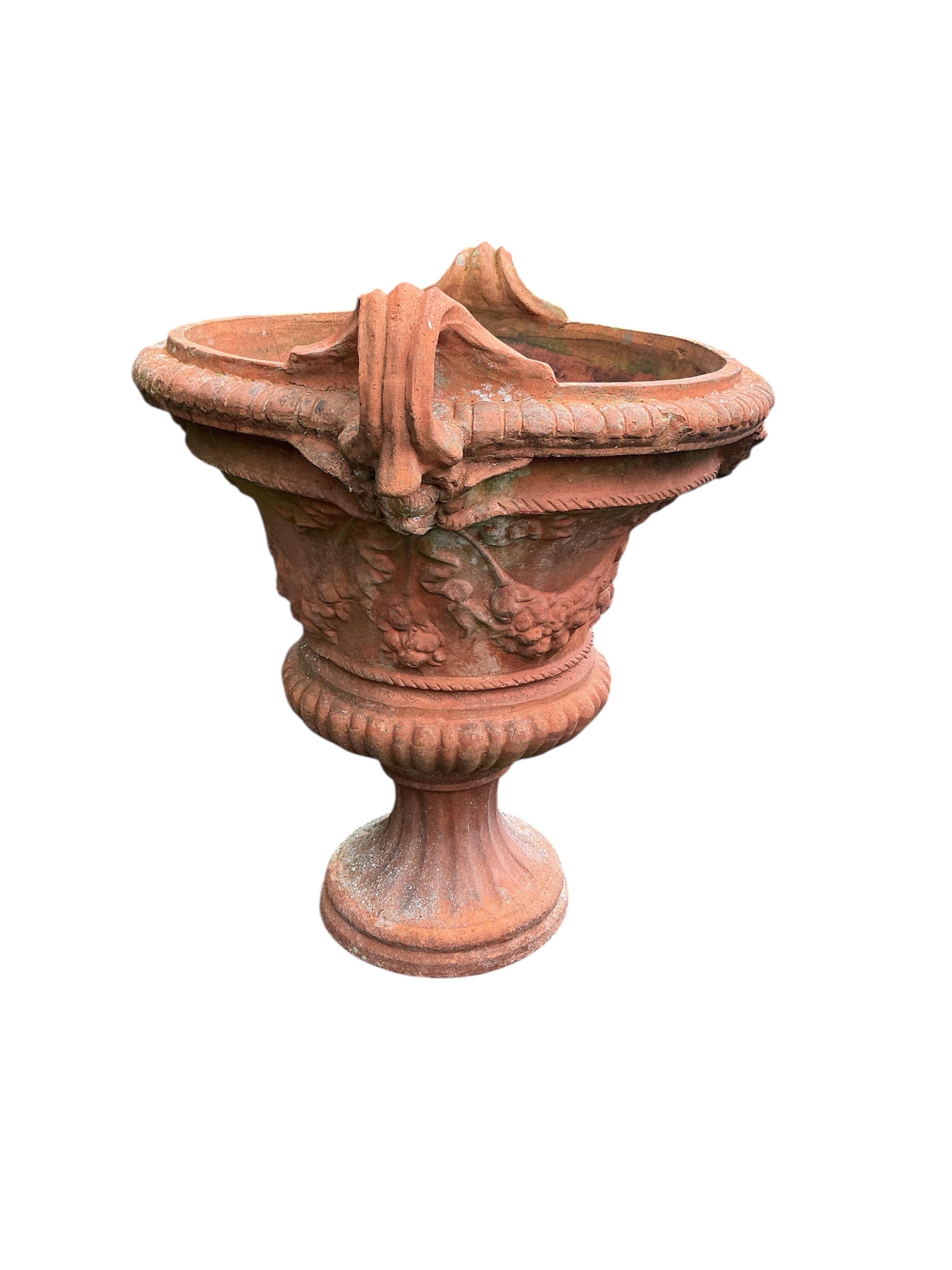 A large circular terracotta planter, diameter 72cm, height 86cm